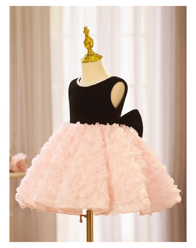 Pink and black velvet and tulle girls party dress with a pearl-trimmed neckline, 3D rosette skirt and big back bow, designed for birthdays and weddings, view 7