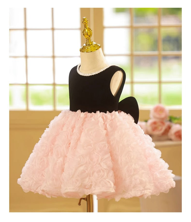 Pink and black velvet and tulle girls party dress with a pearl-trimmed neckline, 3D rosette skirt and big back bow, designed for birthdays and weddings, view 9