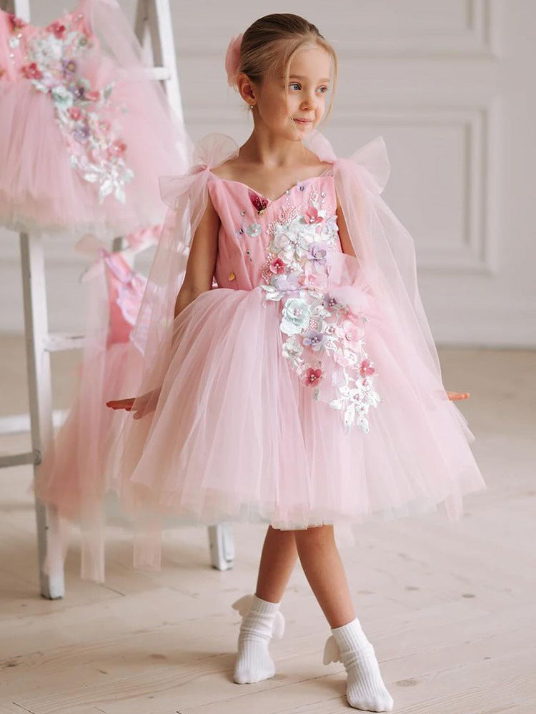 Pink tulle girls dress with 3D floral appliqué, butterfly-wing back and tulle shoulder bows, designed for birthdays and weddings.
