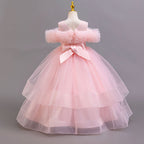 Pink tulle girls ball gown with V back and large satin bow, designed for weddings and flower girls.