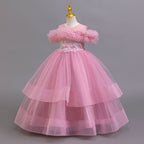 Mauve tulle girls ball gown with off-shoulder ruffle neckline and three-tier tulle skirt, designed for parties and recitals.