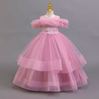 Mauve tulle girls ball gown with off-shoulder ruffle neckline, beaded lace waist and three-tier skirt, designed for weddings and pageants.
