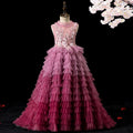 Pink ombre tulle girls gown with floral lace bodice, pearl neck and tiered ruffle train, designed for pageants and formal events.