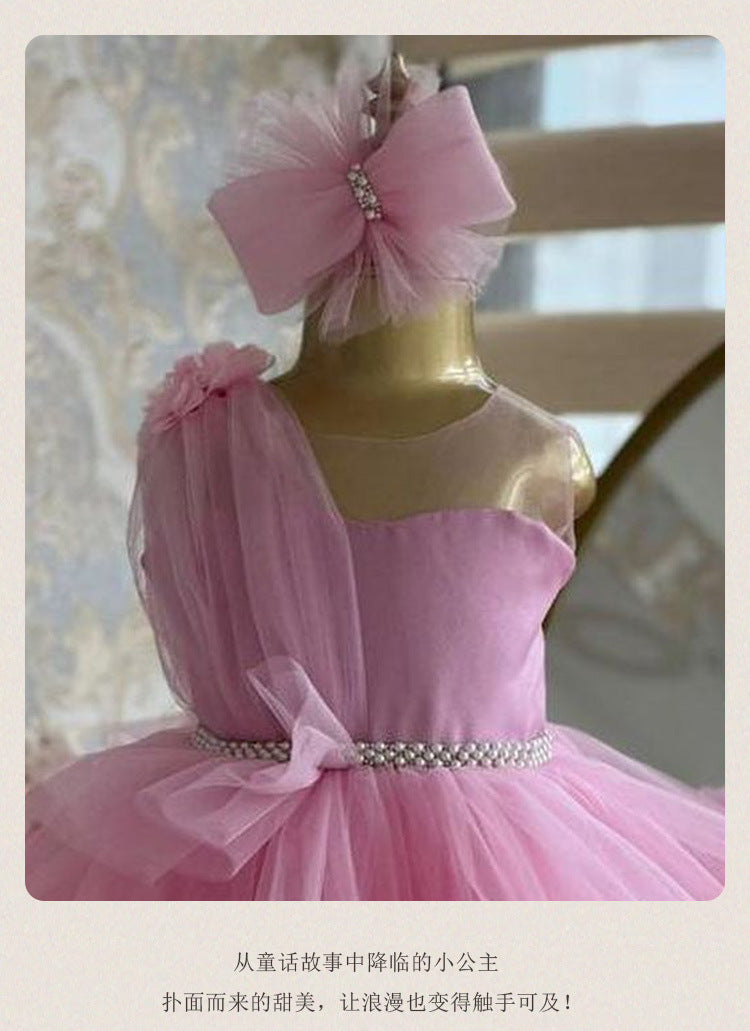 Pink tulle girls dress skirt detail with pearl beaded waist and layered ruffles, designed for birthdays and princess parties.