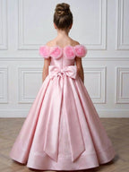 Pink satin girls gown with a large back bow and full ankle-length skirt, designed for weddings and flower girl duties.