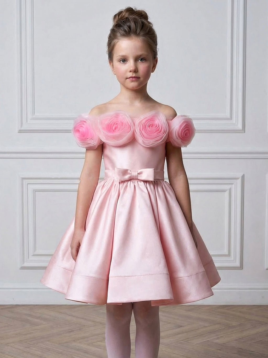 Pink satin girls gown with tulle rosettes and a pleated full skirt, designed for weddings and pageants.
