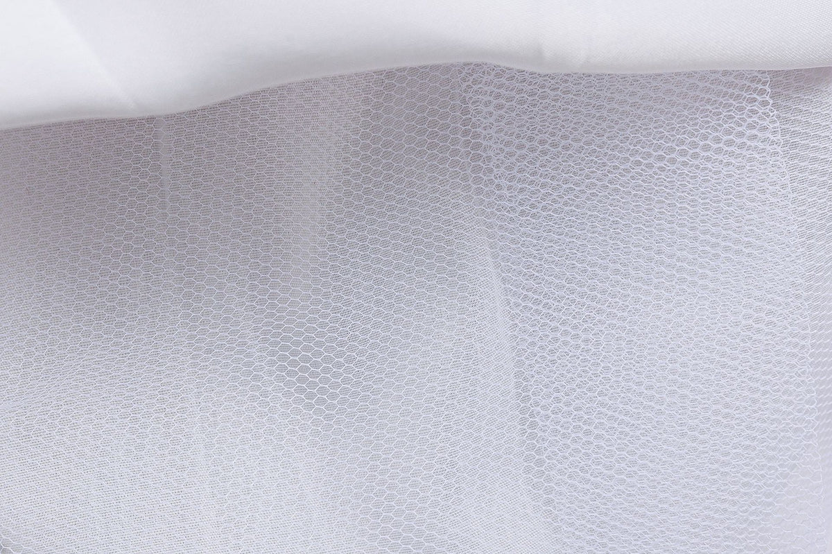 White mesh underlayer of a girls printed chiffon princess gown, designed for birthday parties.