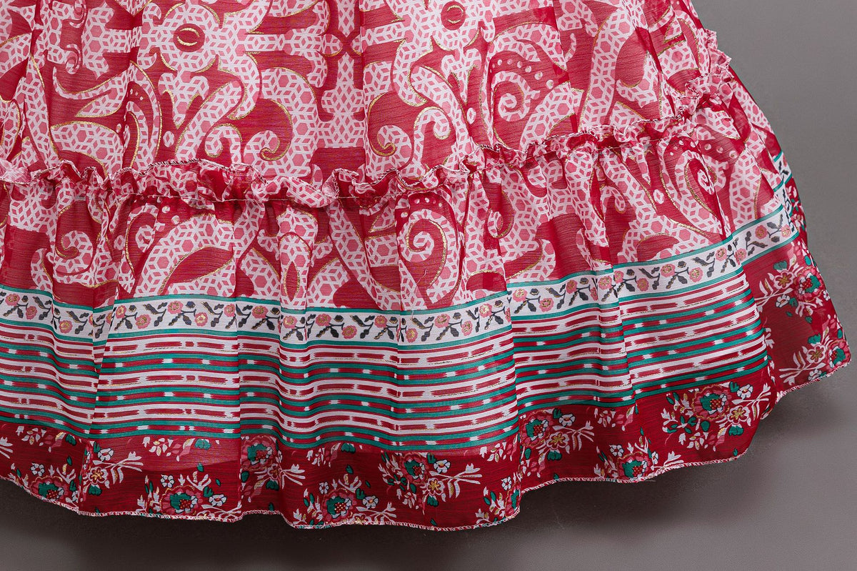 Red printed chiffon tiered skirt of a girls princess gown with striped border bands, designed for birthday parties.