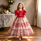 Red printed chiffon girls princess gown with puff sleeves, pearl belt and tiered skirt, designed for birthday parties.