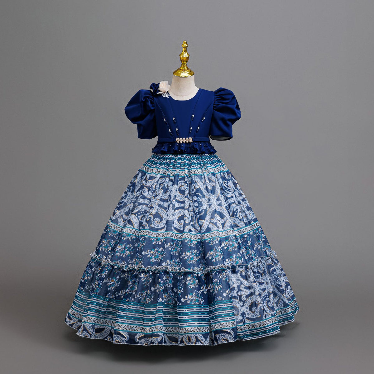 Royal Blue printed chiffon girls princess gown with puff sleeves, pearl belt and tiered skirt, designed for birthday parties.