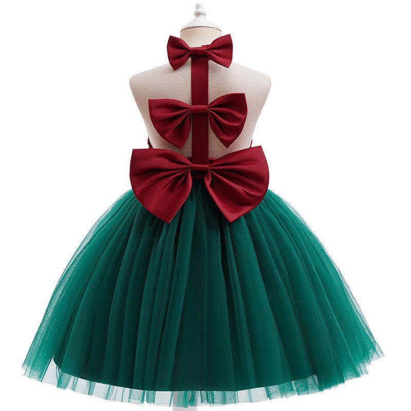 Back view of the girls Christmas dress showing the open back and the large red satin bow at the waist.