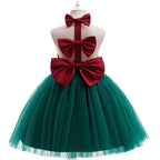 Back view of the girls Christmas dress showing the open back and the large red satin bow at the waist.