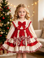 Red and ivory girls Christmas dress with a red chest bow and two plaid bows on the skirt, designed for Christmas parties.