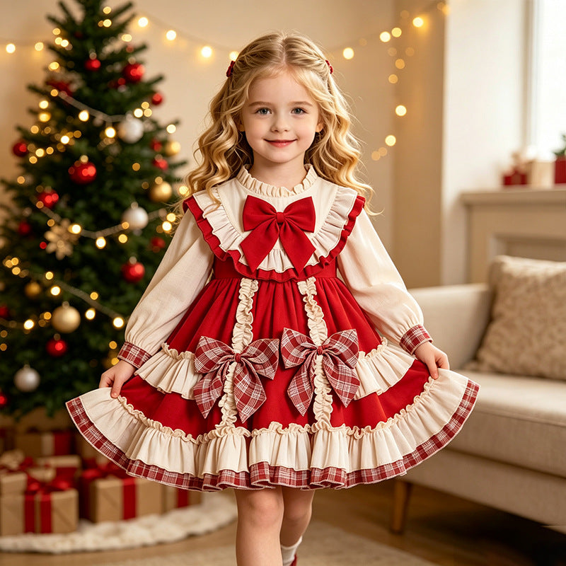 Red and ivory girls Christmas dress with plaid bows and full tiered ruffle skirt, designed for family photos.