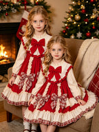 Red and ivory girls Christmas dress with a big red chest bow, plaid skirt bows and tiered ruffles, designed for Christmas parties.