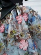 Floral girls party dress skirt close-up with pink 3D flower appliqué and blue butterfly print, designed for birthday parties.