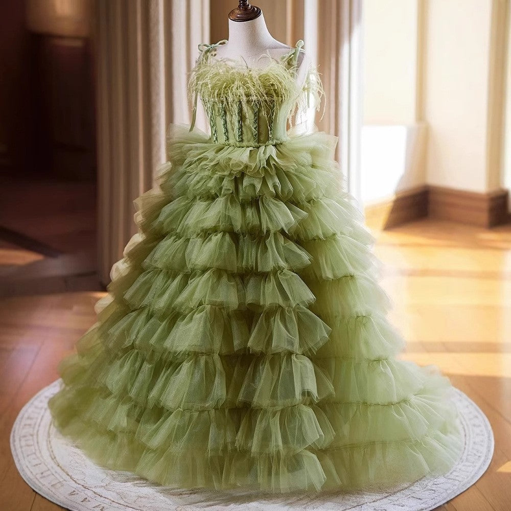 Layered ruffle tiers on the sage green princess dress for girls, side view.