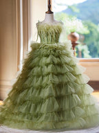 Sage green girls formal dress with its full ruffled skirt, side view 2, for a portrait session.