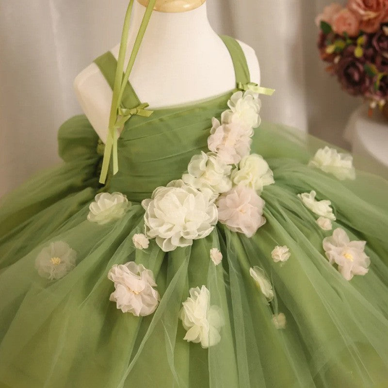 Close-up of the ivory chiffon flower cascade on the bodice of the sage green princess dress for girls.