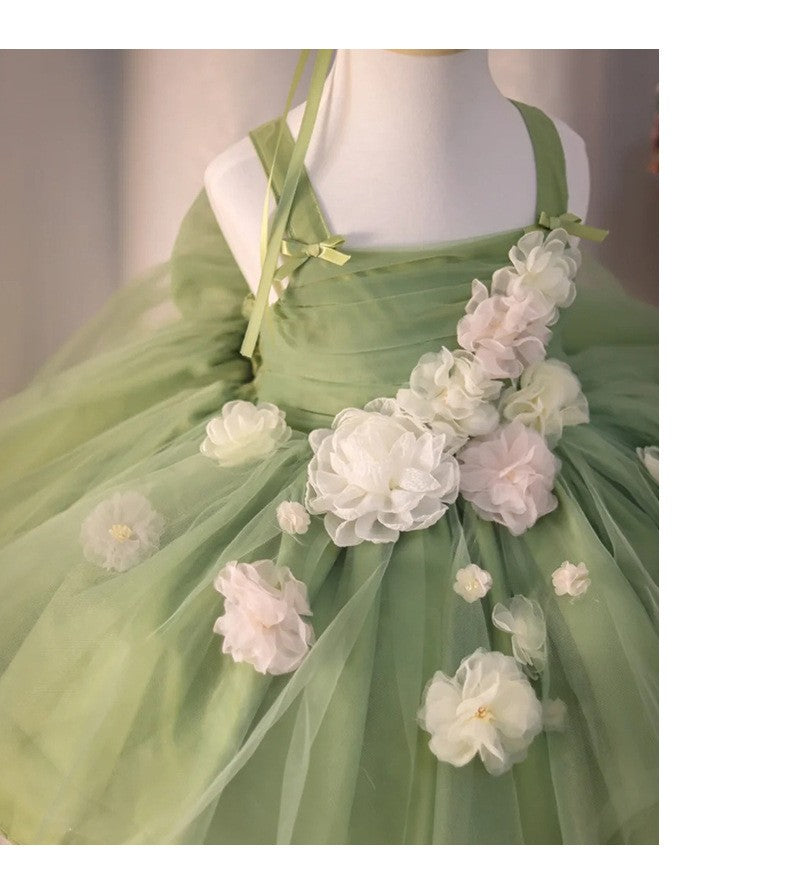 Detail of the hand-sewn ivory blossoms where the flower trail meets the tulle skirt, view 3.