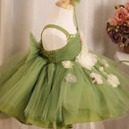 Close-up of the square neckline and shirred bodice on the sage green girls party dress.