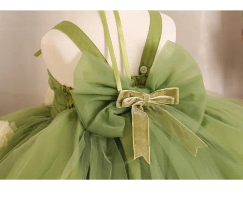 Close-up of the velvet bow knot on the tulle back sash of the sage green tulle princess dress.