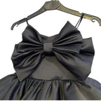 Close-up of the oversized satin bow and straight neckline on the black girls party dress.