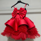 Red bow-front tulle dress, one of the princess dresses for girls, showing the full puffy skirt, front view 2, for parties.