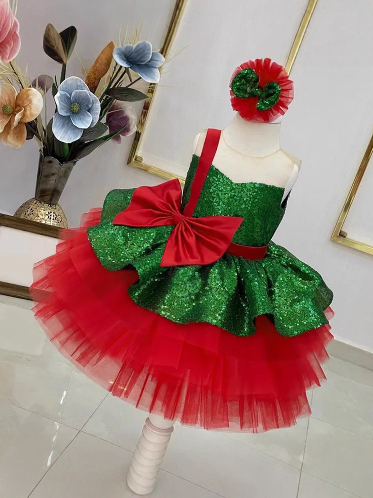 Green sequin bodice and red tiered tulle girls tutu dress with an oversized red bow, designed for Christmas parties.