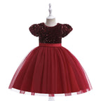 Burgundy sequin and tulle girls party dress with short puff sleeves, satin waistband and back bow, designed for birthdays and holiday parties.