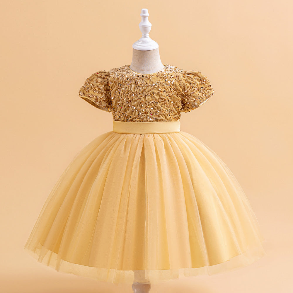 Champagne sequin and tulle girls party dress with short puff sleeves, satin waistband and back bow, designed for birthdays and holiday parties.