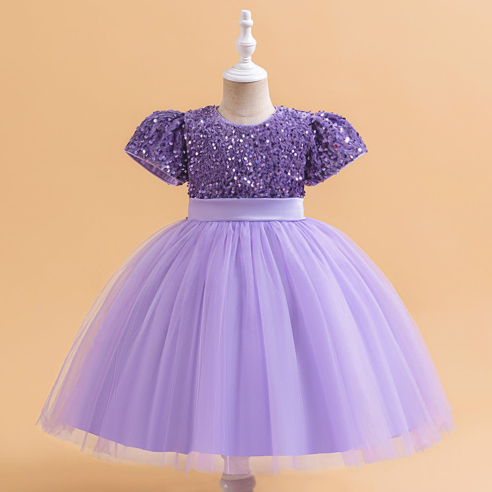 Purple sequin and tulle girls party dress with short puff sleeves, satin waistband and back bow, designed for birthdays and holiday parties.