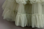 Sage Green tulle girls ball gown ruffle tiers close-up, designed for flower girls and weddings.