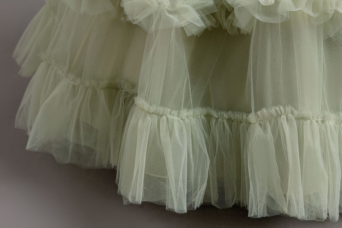 Sage Green tulle girls ball gown ruffle tiers close-up, designed for flower girls and weddings.