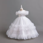 White tulle girls ball gown with ruffled off-shoulder band, lace waist and tiered ruffle skirt, designed for flower girls and weddings, view 2