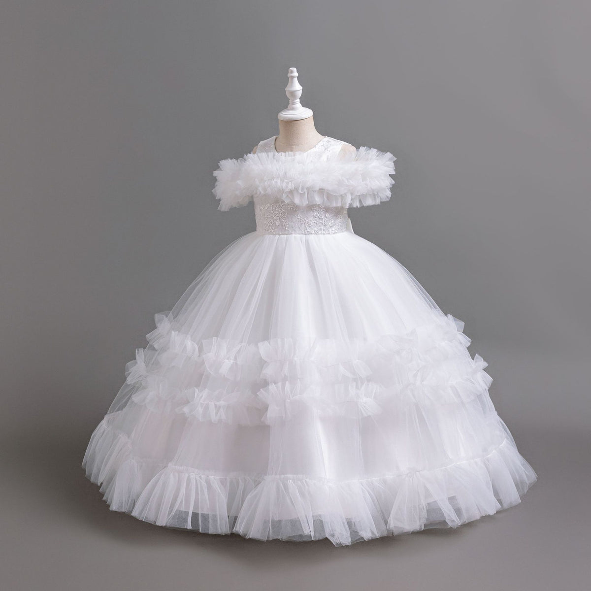 White tulle girls ball gown with ruffled off-shoulder band, lace waist and tiered ruffle skirt, designed for flower girls and weddings, view 2
