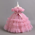 Pink tulle girls ball gown with satin back bow and tiered ruffle skirt, designed for flower girls and weddings.