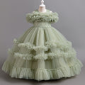 Sage Green tulle girls ball gown with ruffled off-shoulder band, lace waist and tiered ruffle skirt, designed for flower girls and weddings.