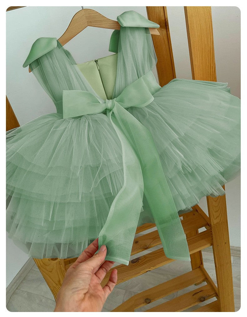 Mint green tulle girls party dress showing the wide sash bow tied at the back.