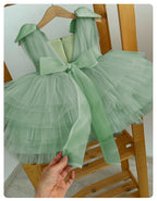 Mint green tulle girls party dress showing the wide sash bow tied at the back.