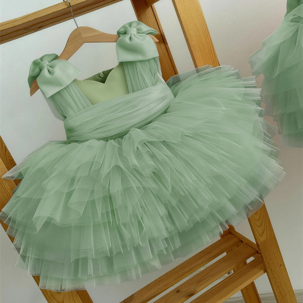 Mint green tulle girls formal dress with a ruched bodice and tiered tutu skirt, front view, for a spring wedding.