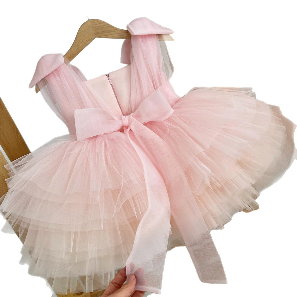 Pink tulle birthday girls dress showing the long organza sash tied in a bow at the back.