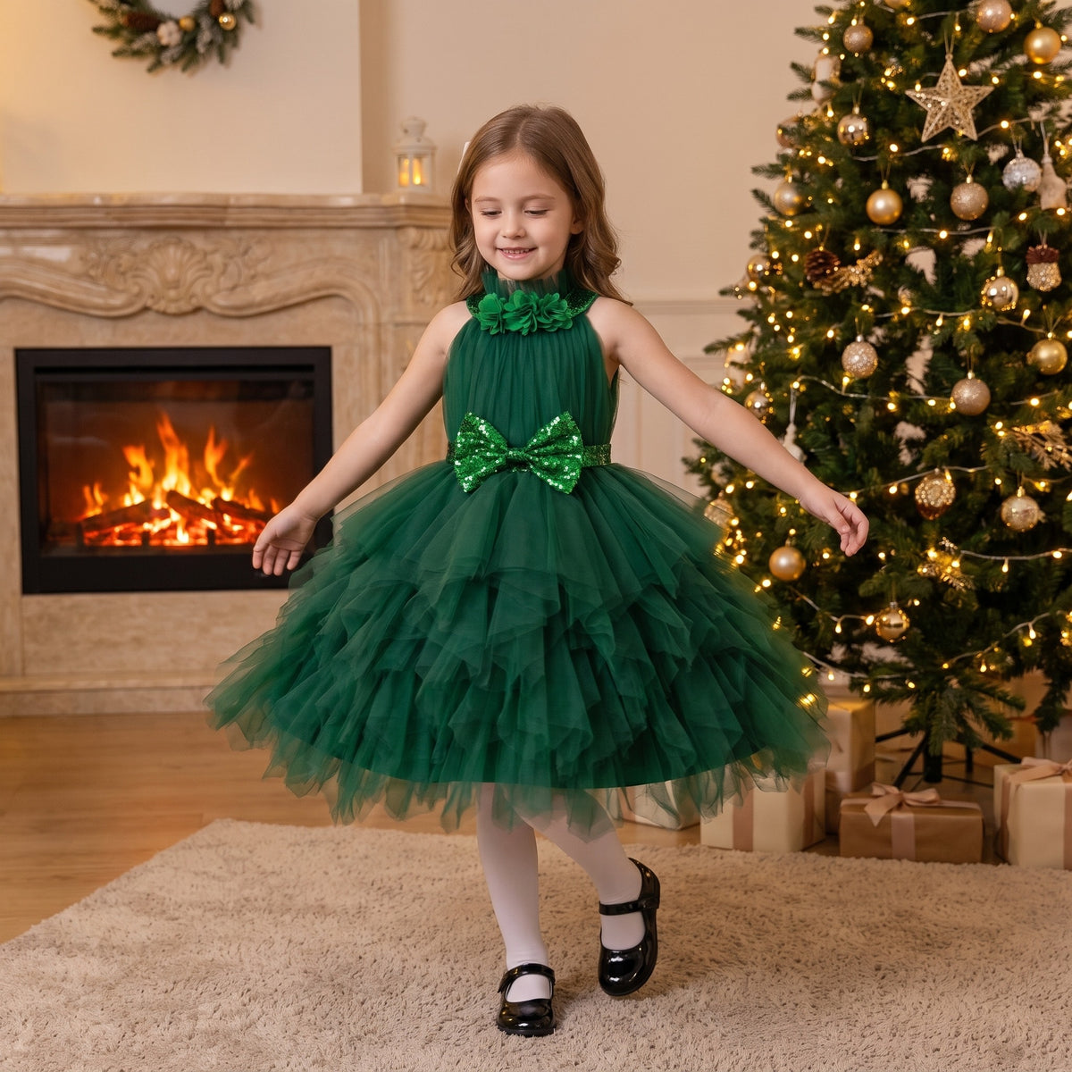 Girl twirling in a dark green tiered tulle holiday dress beside the Christmas tree on Christmas Eve.
