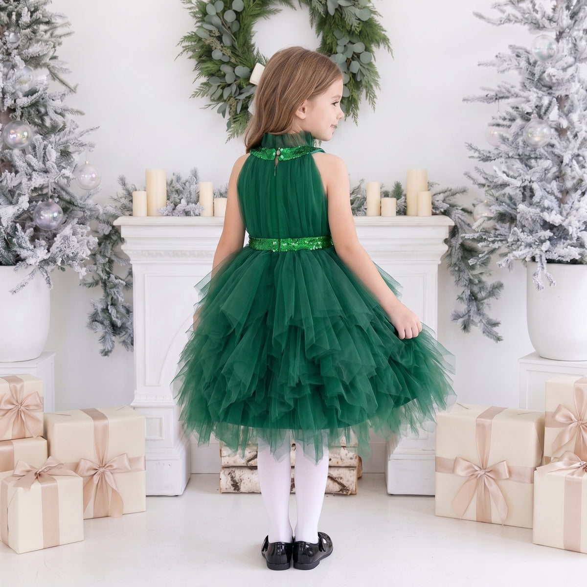 Back of the dark green tulle girls Christmas dress with a ruffled collar, sequin band and tiered ruffle skirt.