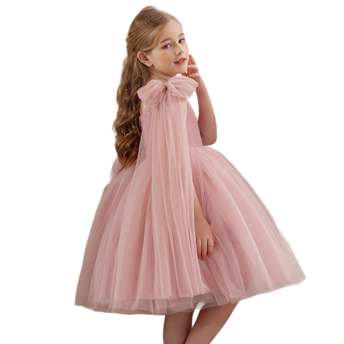 Blush pink tulle flower girl dress with a shoulder bow and full skirt, front view, for a birthday party.