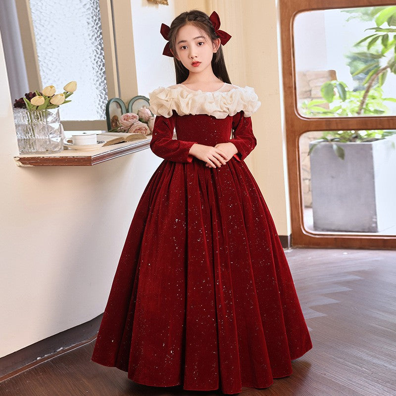 Red velvet gown with a glittered finish and long sleeves, side view 2, for a performance.