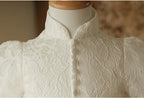 Close-up of the mandarin collar and self-covered button placket on the ivory lace flower girl dress.