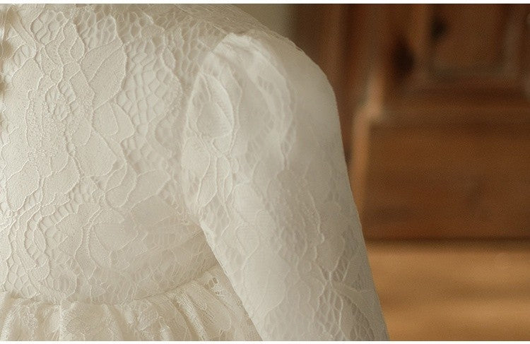 Close-up of the gathered long puff sleeve and floral lace on the ivory girls party dress.