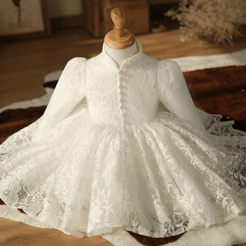 Ivory lace girls formal dress spread on a rug showing the scalloped lace hem, styled scene, view 2.