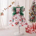 White printed satin girls Christmas dress on a stand with green tulle ruffles and puff sleeves, designed for holiday parties.